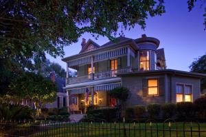 a large house with its lights on at night at Devereaux Shields House in Natchez