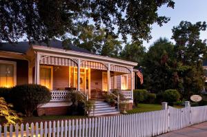 a house with a white fence in front of it at Devereaux Shields House in Natchez +17 photos
