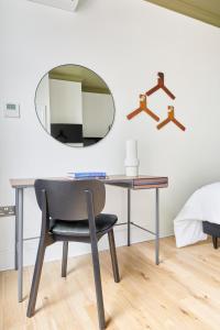 a desk with a chair and a mirror at Sonder Camden Road in London