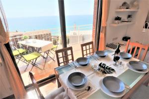 a dining table with a view of a balcony at Carmen Seaview & Beach - Apartment in Montgat