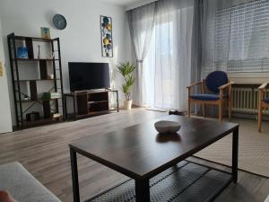 a living room with a coffee table and a tv at Ferienwohnung Wildbad Süd in Bad Wildbad