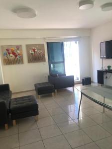 a living room with couches and a glass table at Beautiful 3 BDR Heart of JLM -Modern with Huge Balcony in Jerusalem