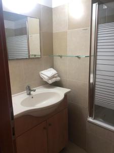 a bathroom with a sink and a mirror at Beautiful 3 BDR Heart of JLM -Modern with Huge Balcony in Jerusalem