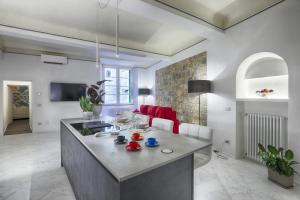 a kitchen with a large island in a living room at Dimora storica - Palazzo del Taja in Siena