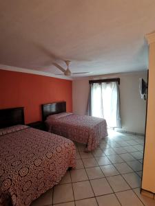Postel nebo postele na pokoji v ubytování Hotel Boutique Real Tequila