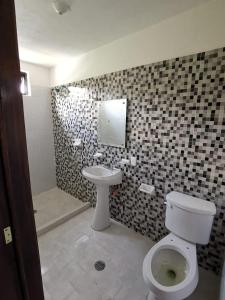 a bathroom with a toilet and a sink at Hotel Boutique Real Tequila in Tequila