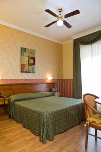 Postel nebo postele na pokoji v ubytování Hotel Verdi