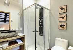 a shower stall in a bathroom with a toilet at Chalet 30 Chemin des Skieurs by Chalets Alpins in Stoneham +33 photos