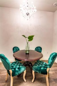 una sala da pranzo con tavolo e sedie verdi di The Alexandre a New Orleans