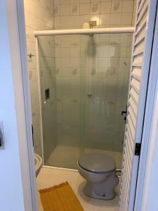 a bathroom with a toilet and a glass shower at Pousada Marques in Paraty