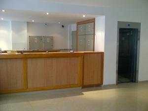 a court room with a desk and a mirror at Hotel Pedraza in Buenos Aires