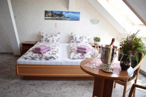 a small bedroom with a bed and a table at Hotel Carola in Schönheide