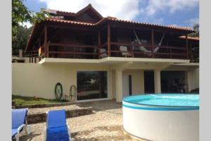 a house with a swimming pool in front of it at Casa de Madeira in Palmaz