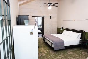 a bedroom with a bed and a refrigerator at Cotton Court Hotel, by Valencia Hotel Collection in Lubbock +32 photos