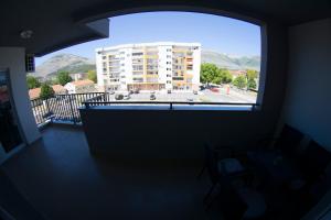 a large window in a room with a large building at Apartman Sunlight in Trebinje