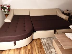 a bed in a small room with at Cazare apartament cu 2 camere in Nehoiu