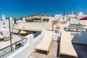 a balcony with chairs and a view of the city at Lux house with outdoor jacuzzi and sea view in Santorini in Emporio Santorini