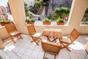 un patio con 3 sedie e un tavolo sul balcone di Fabuleux Studio a Beausoleil