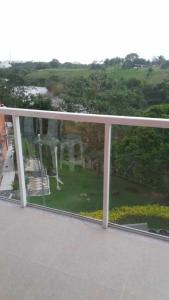 a view of a garden seen through a window at Village dos Pássaros Apartamento in Guarapari