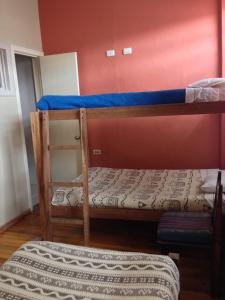 two bunk beds in a room with a mattress at El Cafecito Hostel Cuenca in Cuenca