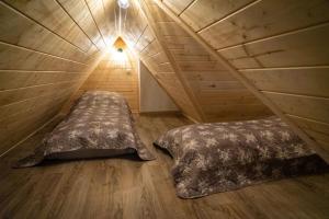 a bedroom with two beds in a attic at Willa911_Apartamenty in Rzepiska