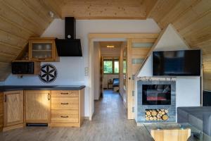 a kitchen with a fireplace in a house at Willa911_Apartamenty in Rzepiska