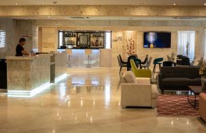 a lobby of a hotel with a man standing at a counter at Hotel Súper Estrellas in Barrancabermeja