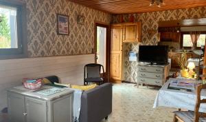 a living room with a couch and a television at L'Eterle des Bauges in Aillon-le-Jeune +24 photos