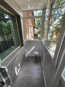 a balcony with two chairs and two windows at Apartment on Tarkovskogo 2 in Kropyvnytskyi