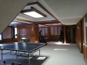 an empty room with a ping pong table in it at Green Village in Calgary