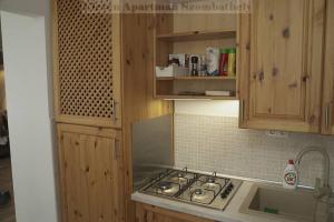 a kitchen with a stove and a counter top at Eleven Apartman in Szombathely