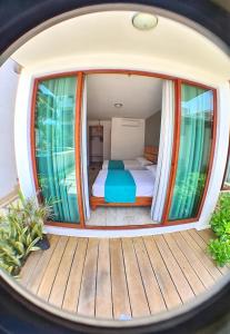 a circular room with a bed and a deck at Hotel Casa Shula, Acapulco in Pie de la Cuesta