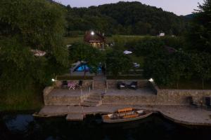 an aerial view of a house with a boat in the water at Casa Dellˇ Amore in Bihać