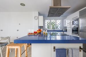 a kitchen with a blue counter top in a room at Cádiz punta carnero 1 in Algeciras