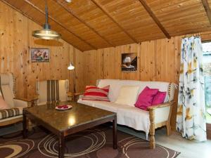 een woonkamer met een bank en een tafel bij 6 person holiday home in Bjert in Binderup Strand
