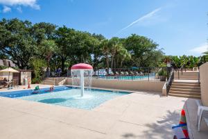 a pool with a water fountain in a park at Ocean View at Island Club by Capital Vacations in Hilton Head Island