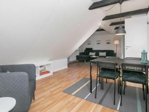 a kitchen and living room with a table and chairs at Apartment Løkken in Løkken