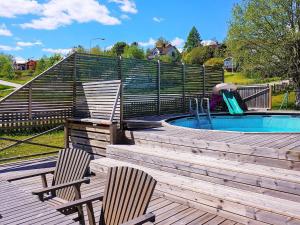 a deck with two chairs and a swimming pool at 8 person holiday home in BILLINGSFORS in Billingsfors