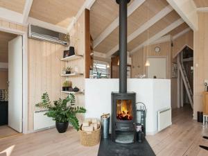 a fireplace in a living room with a stove at 6 person holiday home in Ebeltoft in Ebeltoft