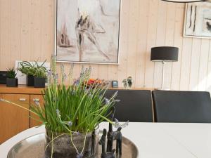 a table with a potted plant on top of it at 6 person holiday home in Ebeltoft in Ebeltoft