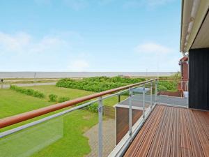 a balcony with a view of the ocean at 6 person holiday home in Hemmet in Falen