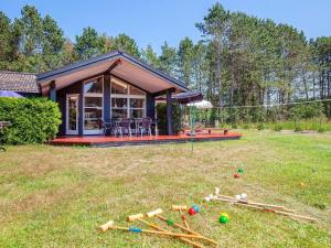 a small house in a yard with a bunch of equipment at 8 person holiday home in R dby in Rødby