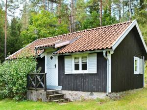SvarvaremålaにあるOne-Bedroom Holiday home in Hallabro 1の赤屋根の小さな白黒住宅