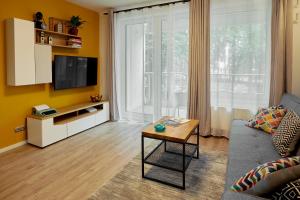 Televízia a/alebo spoločenská miestnosť v ubytovaní Sherlock Apartment