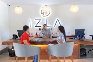a group of three people sitting at a table at Izla Beach Front Hotel in Isla Mujeres