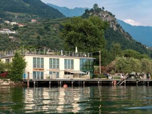 a house on a dock on a body of water at Belvilla by OYO Casa Giada in Marone
