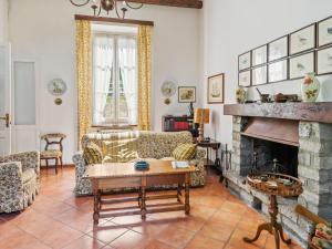 a living room with couches and a fireplace at Belvilla by OYO Belle Epoque in Meina
