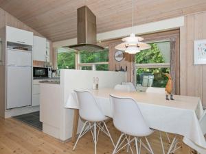 a kitchen and dining room with a white table and chairs at 6 person holiday home in Silkeborg in Silkeborg