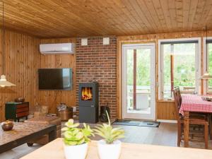 a living room with a brick wall and a fireplace at 6 person holiday home in Glesborg in Glesborg
