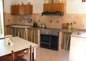 a kitchen with a stove and a sink at Casa Giordano in Guardavalle